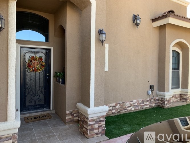 A house entrance with a glass door and a wreath on it.
