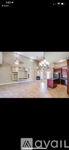 A room with a chandelier and a cabinet.
