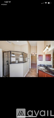 A modern kitchen with a glass enclosed cabinet.