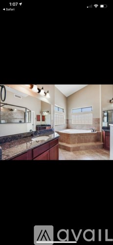 A bathroom with a bathtub and a shower.