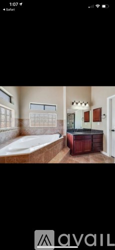 A bathroom with a tub and a vanity.