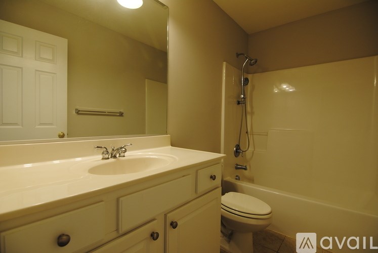 A bathroom with a sink, toilet, and bathtub.