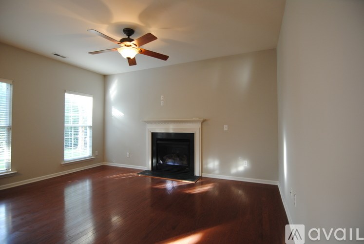 A room with a fireplace and a ceiling fan.