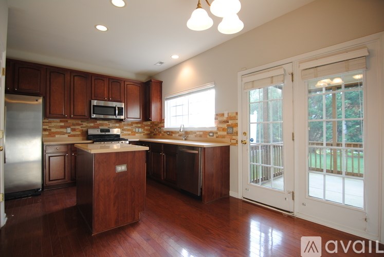 A kitchen with wooden cabinets and a refrigerator.