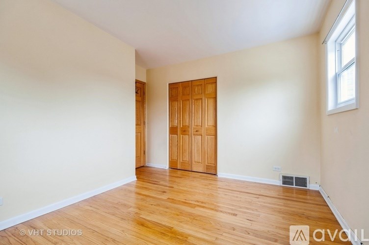 A room with wooden floors and a wooden door.