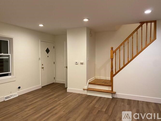 A room with a wooden staircase and a window.