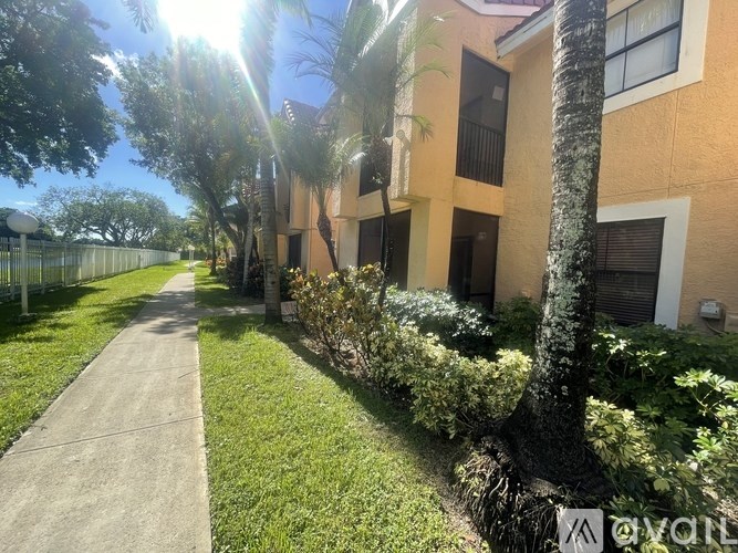 A sunny day at the apartment complex with a clear blue sky.