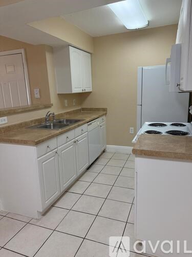 A kitchen with brown cabinets and a granite counter top.