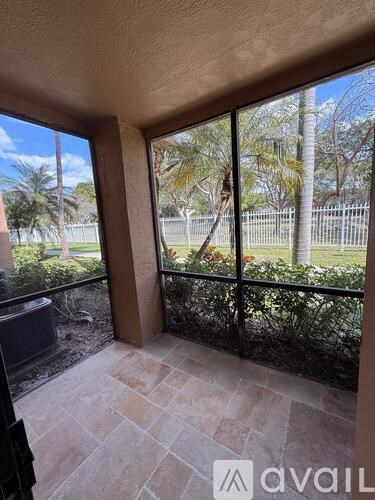 A balcony with a view of a fence and trees.
