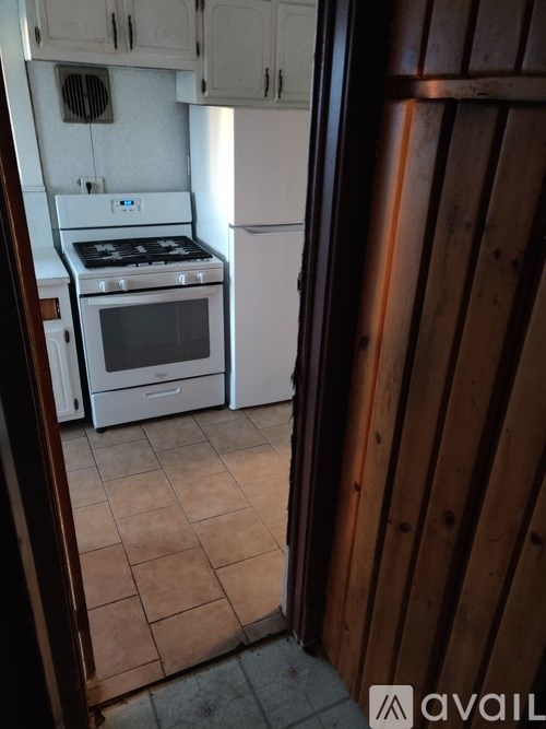A kitchen with a white stove and white oven.