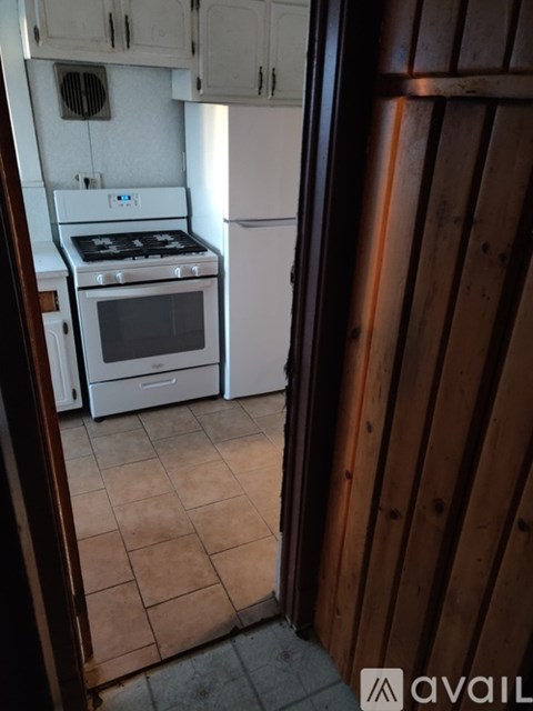 A kitchen with a white stove and white oven.