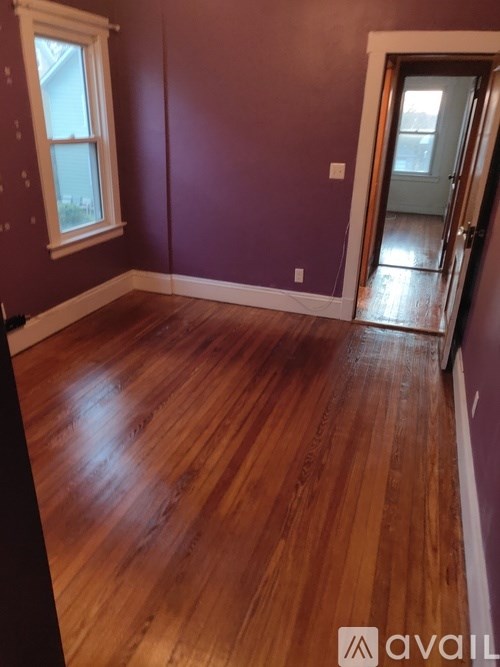 A room with wooden floors and a window.