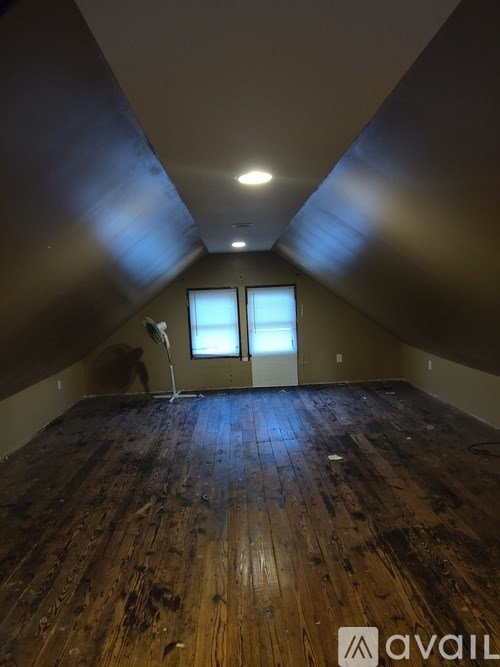 A room with wooden floors and a window.