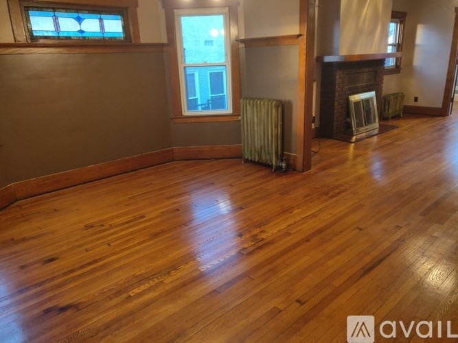 A room with wooden flooring and a window.