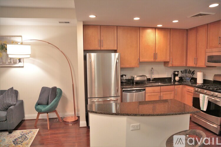A kitchen with wooden cabinets and a refrigerator.