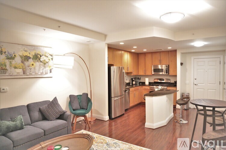 A kitchen with a refrigerator, oven, and microwave.