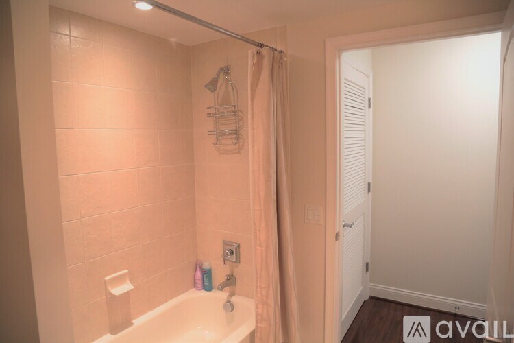 A bathroom with a tub and a shower curtain.