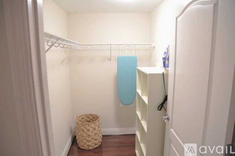 A small room with a white wall and a basket on the floor.