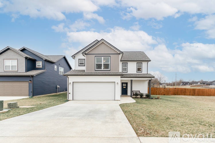 A house with a garage is situated in a residential area.