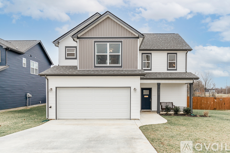 A two-story house with a garage is for sale.