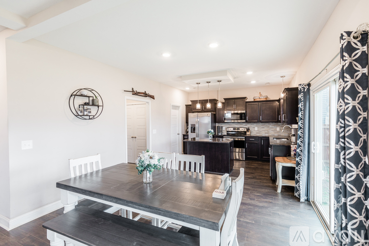 A modern kitchen with a dining table set for four.