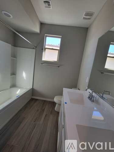 A bathroom with a toilet, sink, and bathtub.