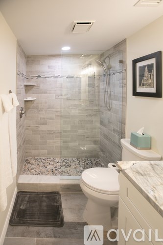 A bathroom with a toilet, sink, and shower.