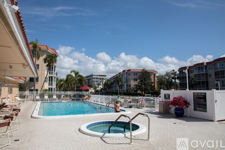 A woman is sitting on a chair by a small pool.