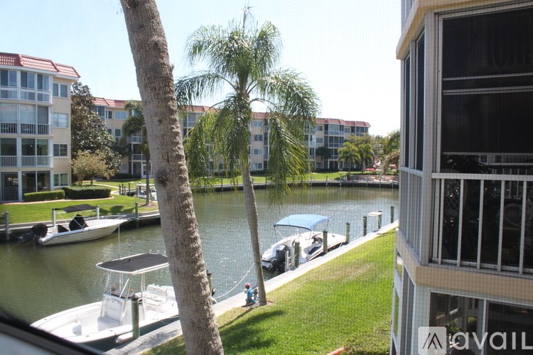 A view from a balcony overlooking a body of water with boats docked at a pier.