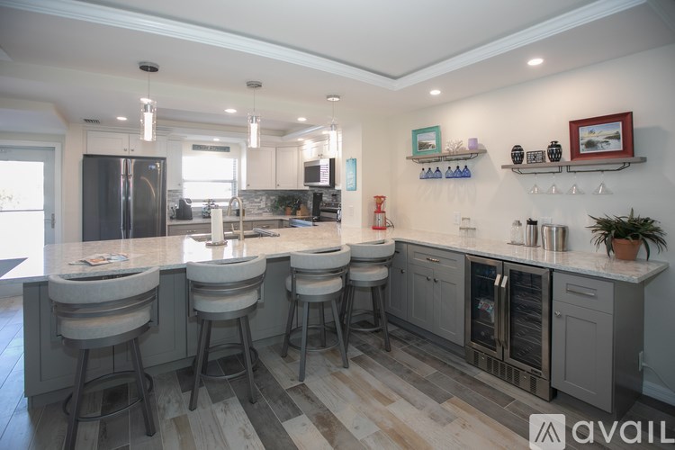 A kitchen with a bar area and stools.