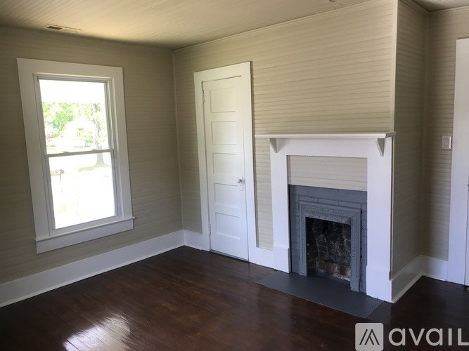 A room with a fireplace and a window.