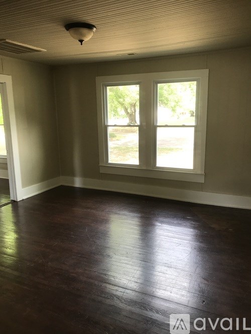 A room with wooden floors and a window.