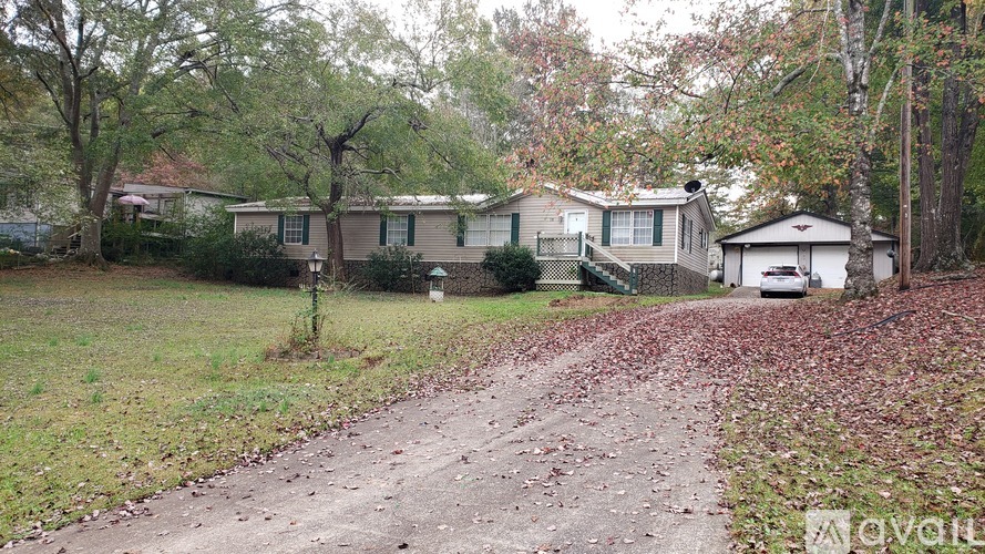 A residential area with houses and a dirt road.