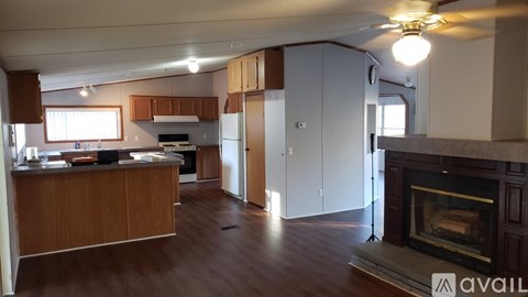 A kitchen with wooden cabinets and a fireplace.
