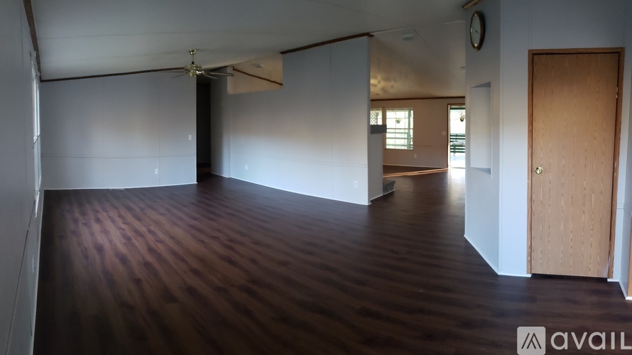 A room with wooden floors and a ceiling fan.