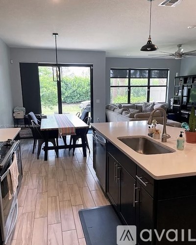 A kitchen with a table and chairs in the middle of the room.