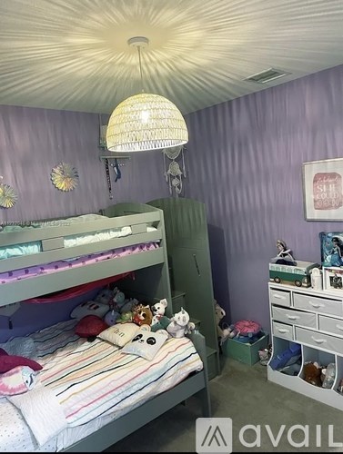 A bedroom with a bunk bed and a dresser.