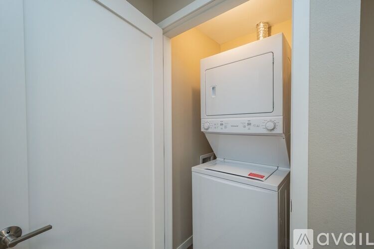 A white dishwasher and oven are in a small kitchen.
