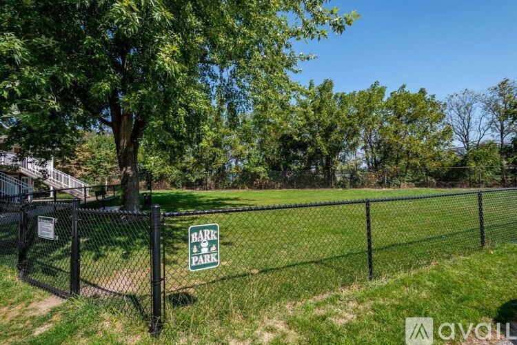A sign that says "Bark Park" is on a fence.