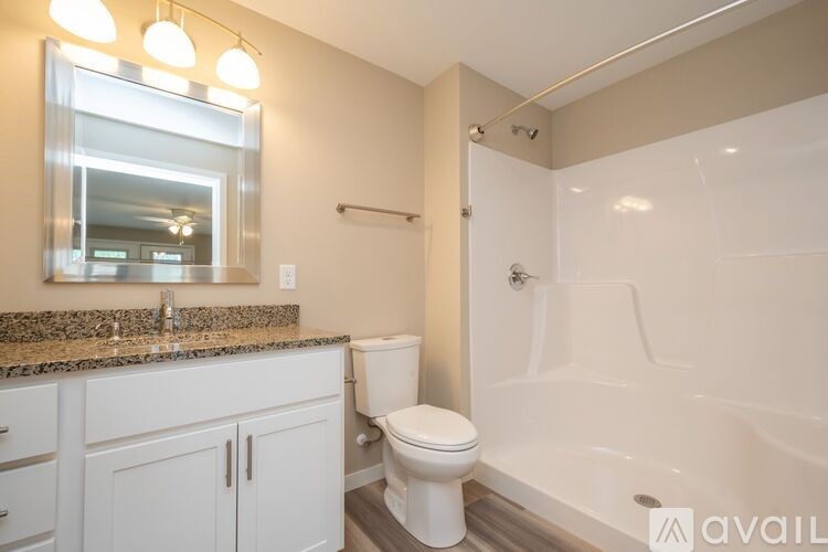 A bathroom with a white toilet and a white bathtub.