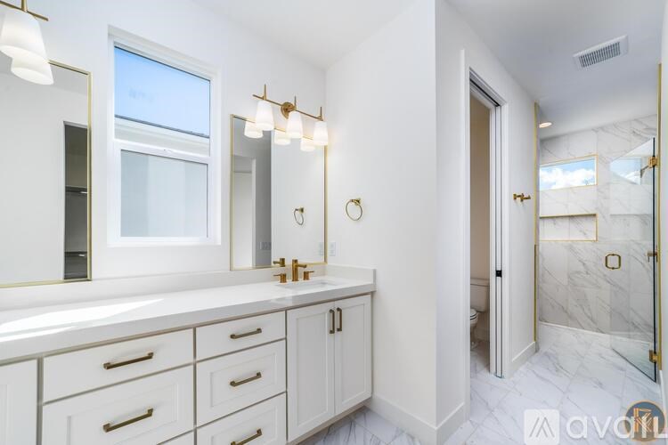 A bathroom with a marble floor and white walls.