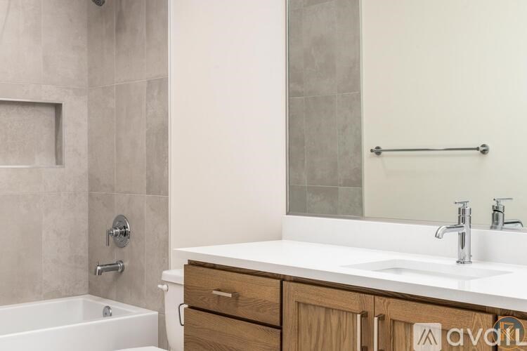A bathroom with a white tub and sink.