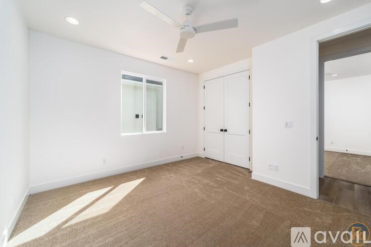 A room with a ceiling fan and a window.
