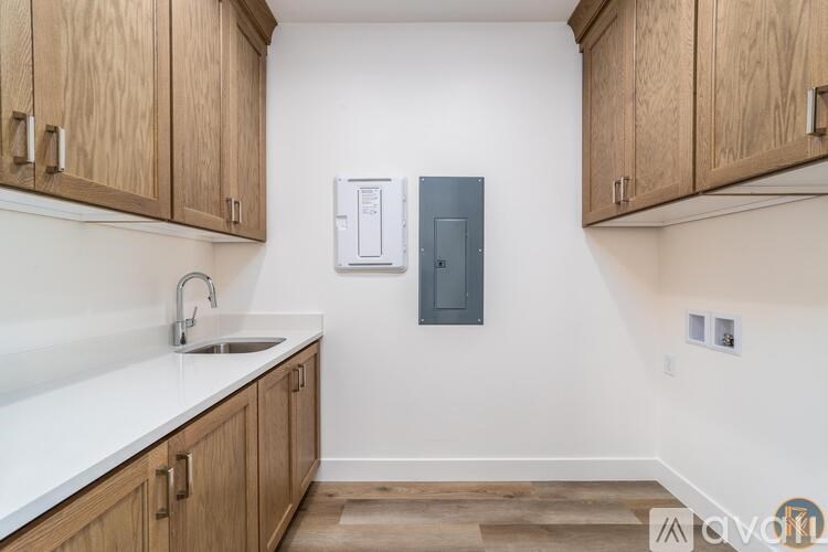 A kitchen with wooden cabinets and a white countertop.