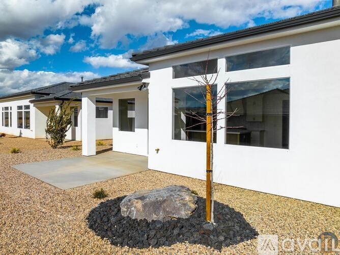 A white house with a yellow pole in front of it.