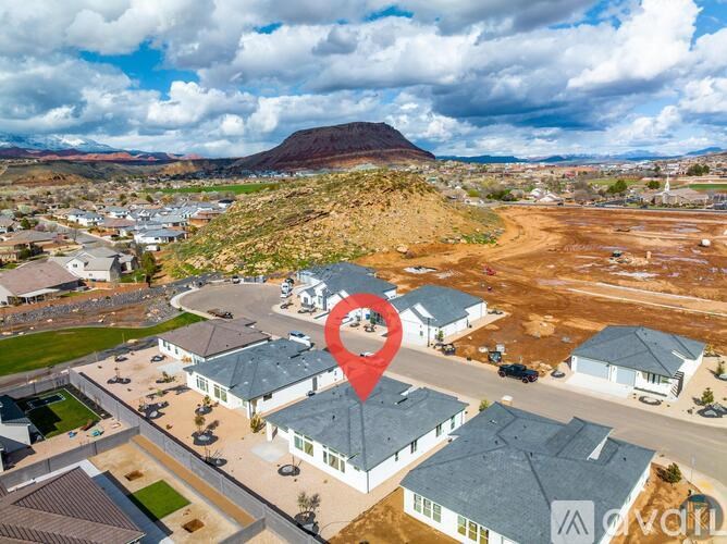 A red location marker is superimposed on a photo of a residential area.