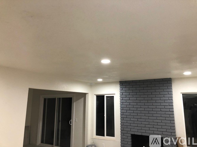 A room with a fireplace and a window.