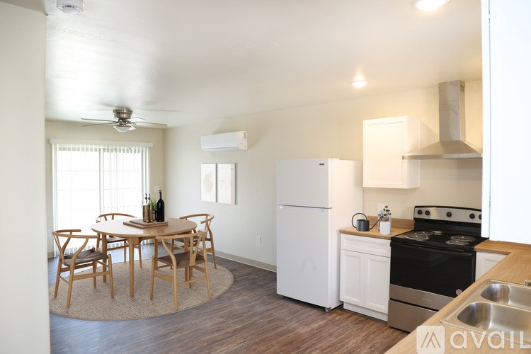 A kitchen with a table and chairs in the middle of the room.