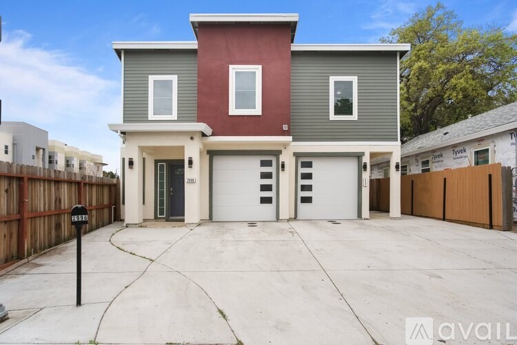 A two-story house with a garage is available for rent.