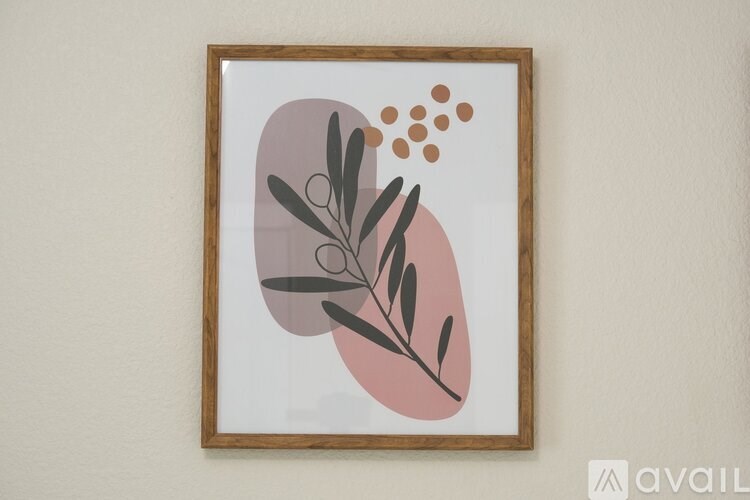 A framed artwork with abstract leaves and dots.